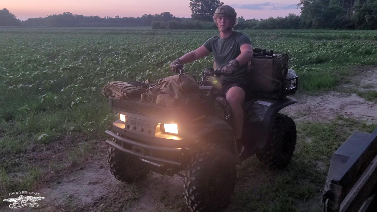 "Captain America" Gabriel Roberts sitting on an ATV bug out vehicle