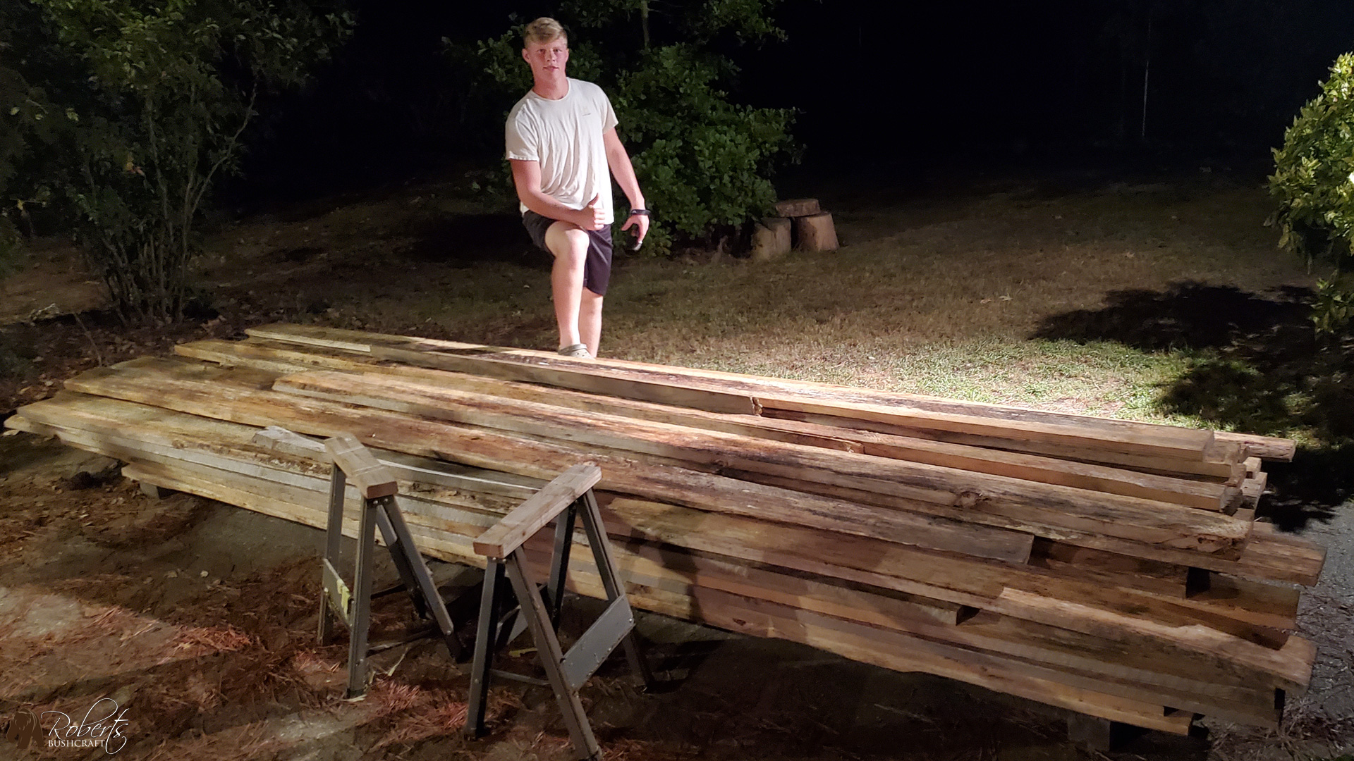 Standing proudly with a stack of pine lumber
