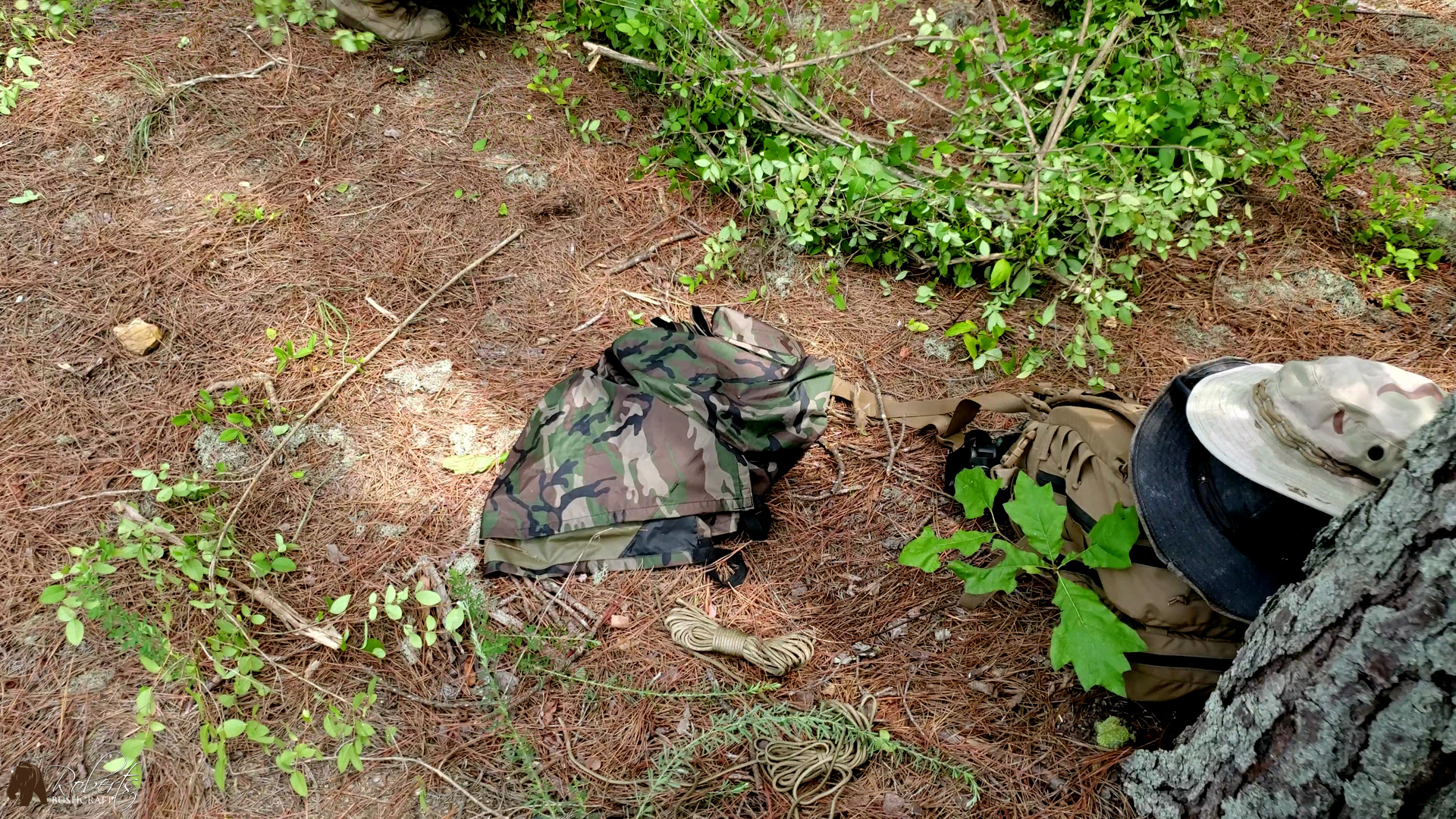 AquaQuest 10x7 Defender tarp next to USMC assault backpack