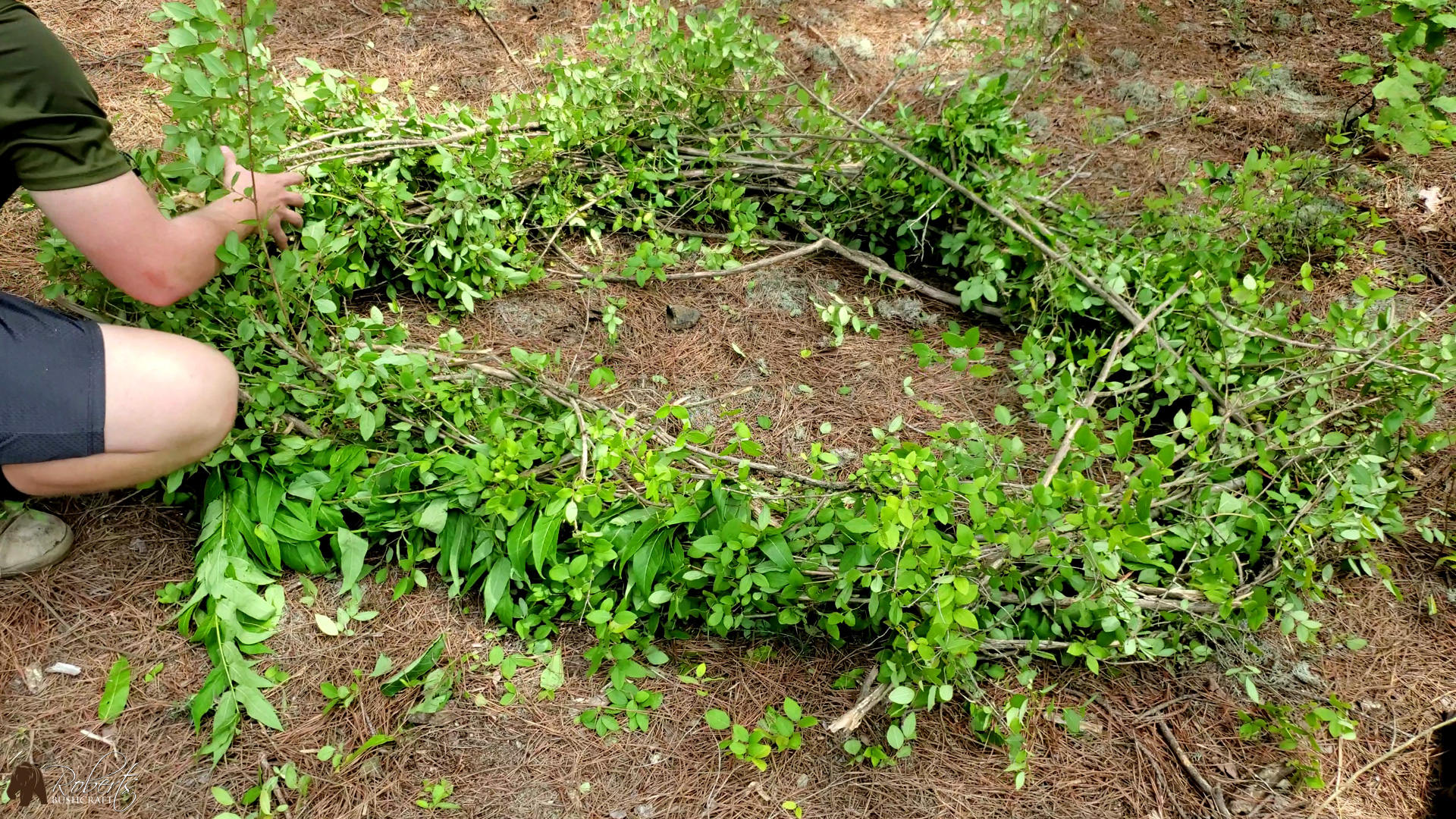 Green limbs and debris tied together to form the frame of the raft