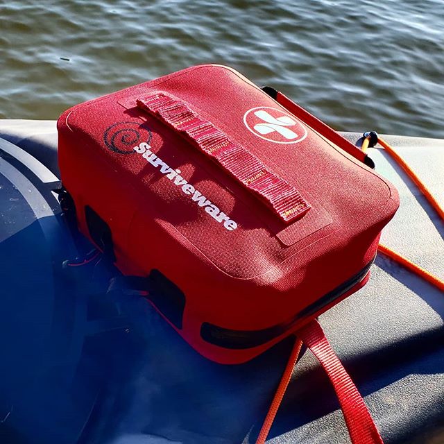 Surviveware waterproof first aid kit on a Pelican kayak
